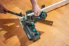 A person is using a miter box and saw to cut a piece of wood. Produktbild-Vorschau