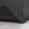 A close-up view of the bottom corner of a dark gray cabinet, showing a hinge and the base of the furniture on a light gray tiled floor. Podgląd zdjęcia produktu