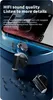 A close-up marketing image of black wireless earbuds with a silver earbud in the background, set against a dark blue, textured surface with small figurines. Produktbild-Vorschau