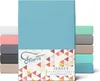 A stack of folded fitted sheets in various colors, with the main product in a bright blue color prominently displayed.