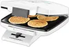 A close-up view of a waffle maker with several waffles inside. Voir les images du produit