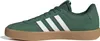A side view of a green Adidas sneaker with white stripes and a brown sole. Produktbild-Vorschau