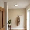 A hallway with a coat rack, a plant, and a door. Náhľad obrázku produktu