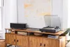 A turntable and speaker are displayed on a wooden media console in a well-lit room. Voir les images du produit
