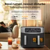 An air fryer is shown in the foreground on a table with drinks, while a person reads in the blurred background. Anteprima dell’immagine prodotto