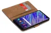 A book-style phone case with two credit cards inserted, displaying a smartphone screen. Podgląd zdjęcia produktu