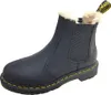 A single black Dr. Martens Chelsea boot with faux fur lining is shown against a white background. Produktbild-Vorschau