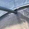 Close-up view of a greenhouse frame and plastic sheeting. Voir les images du produit