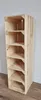 A tall, narrow wooden shelving unit made of stacked crates, with six shelves, stands against a light gray wall and on a wooden floor. Produktbild-Vorschau