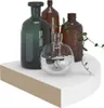 Four glass vases of different colors and shapes are arranged on a white shelf. Náhled obrázku produktu