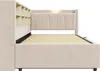 Side view of a beige upholstered bed frame with a headboard featuring storage cubbies. Anteprima dell’immagine prodotto