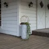 A decorative sphere with lights sits in a planter on a wooden deck next to a white house with two wall lamps. Produktbild-Vorschau
