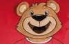 A close-up of a plush teddy bear's face and upper body, wearing a red shirt with a white collar. Náhľad obrázku produktu