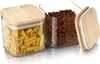 Two glass storage containers with bamboo lids, one filled with penne pasta and the other with coffee beans. A third lid is shown separately. Náhled obrázku produktu