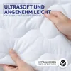Hands holding a soft, white quilted fabric, likely a blanket or duvet, with marketing text overlaid. Produktbild-Vorschau