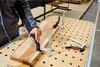 A person is using clamps to secure a piece of wood to a workbench. Anteprima dell’immagine prodotto