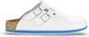 A white Birkenstock Kay SL Pantolette shoe with two buckles and a blue sole, shown from the side against a white background. Produktbild-Vorschau
