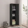 A tall, narrow black metal wardrobe with its door open, revealing shelves with folded clothes and a basket. A wire laundry basket is next to it. The scene is set indoors with a window and plant visible. Produktbild-Vorschau