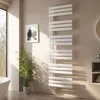 A modern bathroom with a white towel radiator, a plant, and a framed picture on the wall. Voir les images du produit