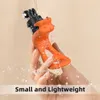 A hand holding an orange camera mount with water splashing around it. Produktbild-Vorschau