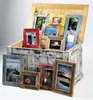 A collection of rustic wooden picture frames of various sizes and colors are displayed inside and around an open wooden chest. Produktbild-Vorschau
