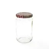 A clear glass jar with a red and white checkered lid. Podgląd zdjęcia produktu