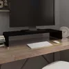 A black monitor stand is placed on a wooden desk, holding a computer monitor. A keyboard and mouse are in front of the stand. Voir les images du produit