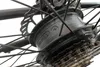 A close-up view of the rear hub of an electric bicycle, showing the motor housing, spokes, and gears. Produktbild-Vorschau