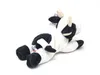 A plush toy cow lying down on a white background. Anteprima dell’immagine prodotto