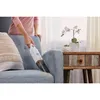 A person is using a handheld vacuum cleaner on a sofa. Produktbild-Vorschau