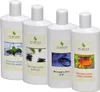 Four white bottles of massage lotion are arranged in a row against a white background. Produktbild-Vorschau