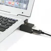 A close-up shot of a black USB hub adapter plugged into a silver laptop. Anteprima dell’immagine prodotto