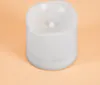 A white LED candle with a flickering effect sits on a light orange background. Produktbild-Vorschau