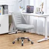 An office chair in front of a desk with a laptop and decorations. Podgląd zdjęcia produktu