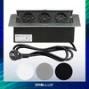 A BROLLUX retractable power outlet with three sockets, a power cord, and three circular color samples (white, gray, black). Produktbild-Vorschau