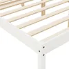 A close-up view of a white wooden bed frame with wooden slats. Produktbild-Vorschau