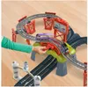 A child's hand is shown interacting with a Thomas the Tank Engine train track set, with trains moving on the tracks. Náhľad obrázku produktu