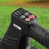 A close-up view of the control panel and handle of a black leaf blower, set against a blurred green grassy background. Produktbild-Vorschau