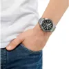 A person wearing a watch on their wrist, with their hand in their jeans pocket. Produktbild-Vorschau