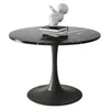 A round black marble table with a dark pedestal base, featuring a small white sculpture of a baby on top of two books. Produktbild-Vorschau