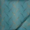 A close-up view of a teal-colored fabric with a wavy gold pattern. Produktbild-Vorschau