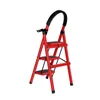 A red step stool with black steps and a black handle is shown against a white background. Produktbild-Vorschau