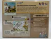 The back of a board game box for 'Trek 12 Himalaya', showing game instructions, game modes, and illustrations. Produktbild-Vorschau