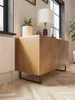 A modern living room with a wooden sideboard and a lamp. Produktbild-Vorschau