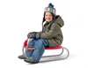 A young boy is sitting on a red and silver sled. Náhled obrázku produktu
