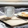 A Stormtrooper helmet-shaped glass sits on a wooden board next to a plate of fried eggs and toast. Anteprima dell’immagine prodotto