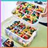 A person is holding a stackable organizer box filled with colorful building blocks. Produktbild-Vorschau