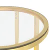 A close-up view of the edge of a round table with a gold frame and a glass top. Podgląd zdjęcia produktu