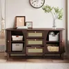 A wooden sideboard with rattan drawer fronts is displayed in a well-lit room, showcasing its storage capabilities and decorative elements. Anteprima dell’immagine prodotto
