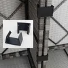A close-up view of black plastic connectors for a polyrattan furniture set. Podgląd zdjęcia produktu